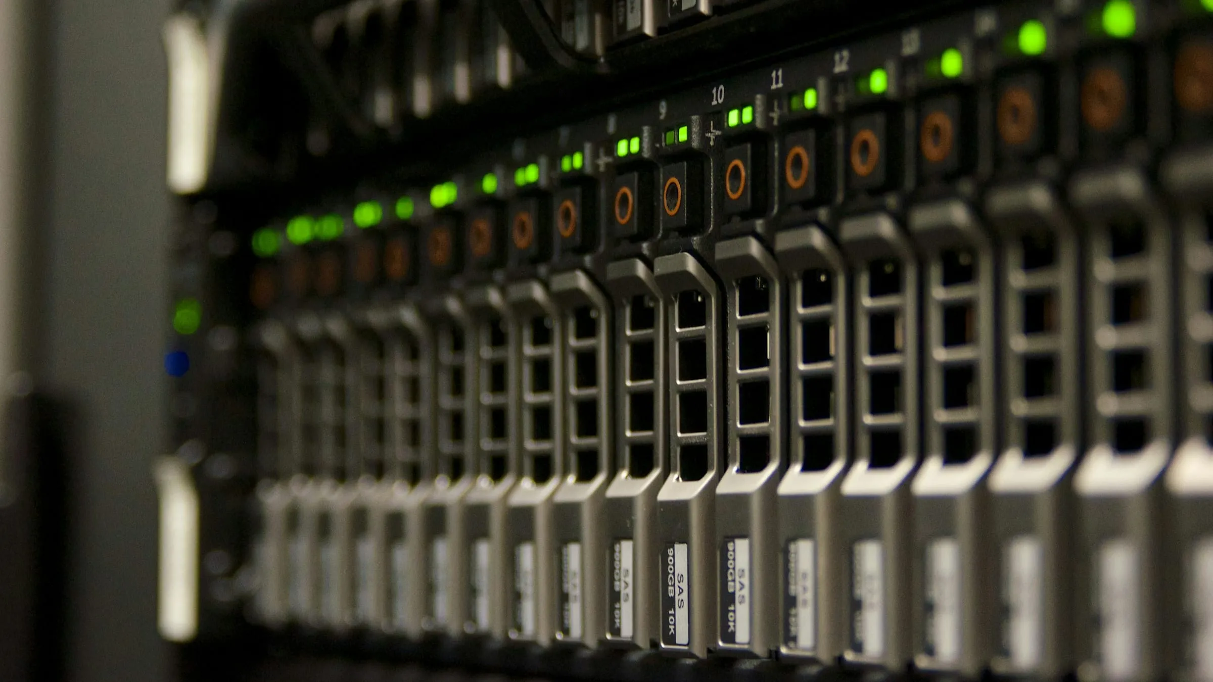 Close-up of a server rack with rows of drive bays and green status lights